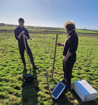 RSPB staff stand next to nest fence